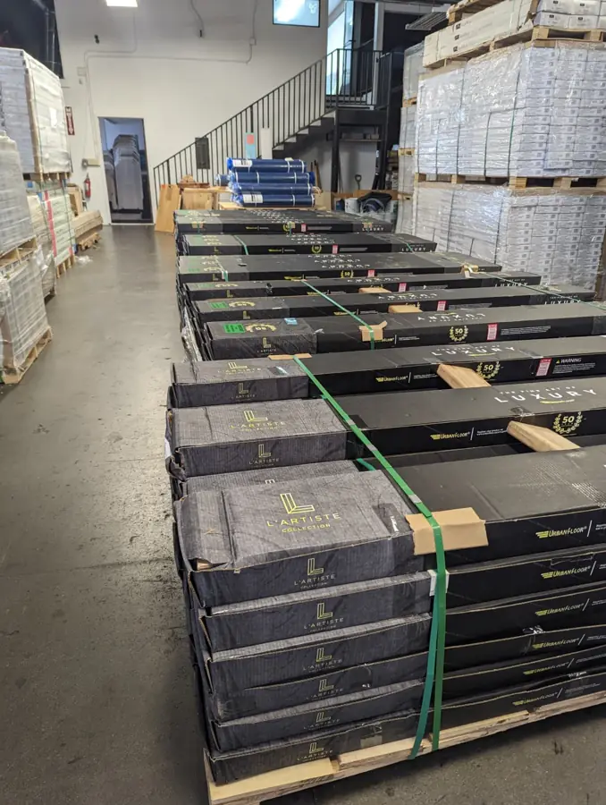 Pallets of boxed hardwood flooring stocked in the warehouse