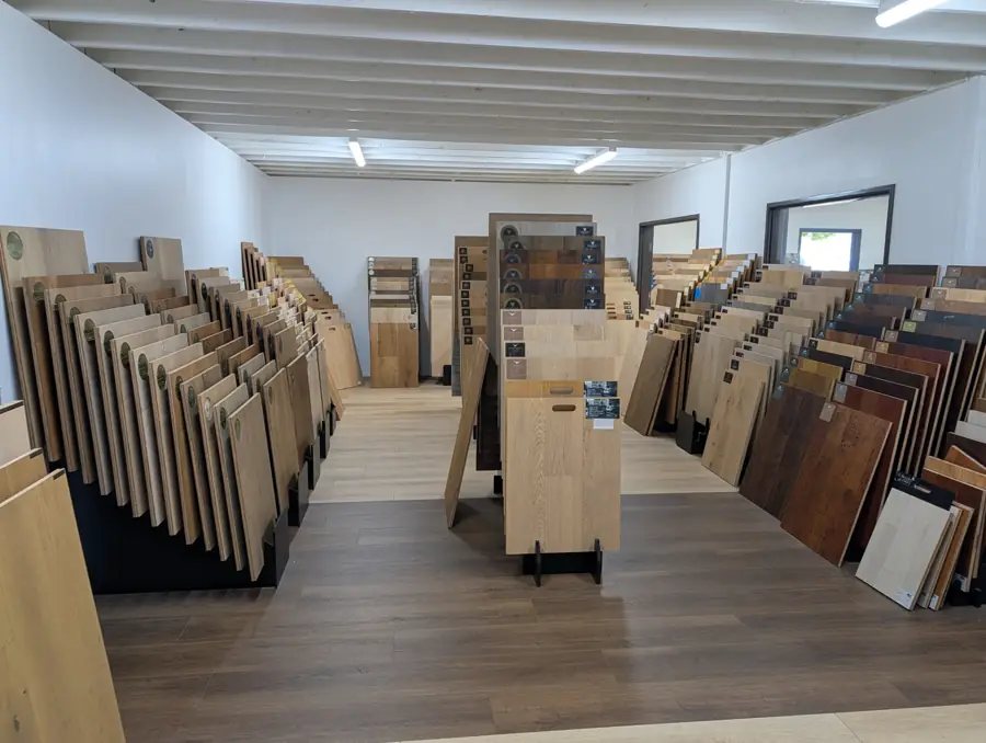 Torrance showroom aisles filled with hardwood and vinyl flooring samples